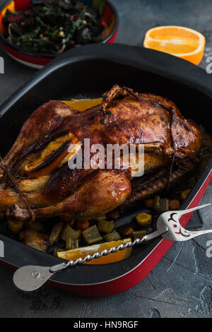 Canard rôti et des oranges sur une plaque en ardoise noire, fermer Banque D'Images