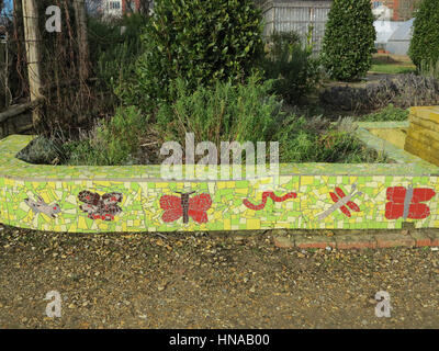 Mosaïque vert mur jardin orné de papillons et libellules Banque D'Images