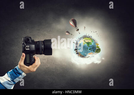 Proche de l'homme main dans la chemise à carreaux photocamera. Éléments de cette image sont meublées par la NASA Banque D'Images