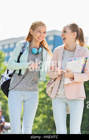 Cheerful young female college students walking in campus Banque D'Images