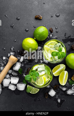 Lime menthe d'été cocktail mojito au rhum et glace en verre sur fond noir Vue de dessus Banque D'Images
