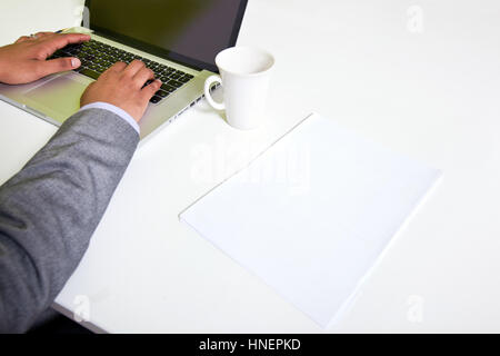 Close up of Indian mans hands typing on laptop Banque D'Images