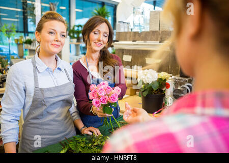 Les fleuristes bouquet vente au client dans shop Banque D'Images