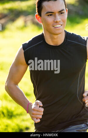 Smiling Mixed Race man running Banque D'Images