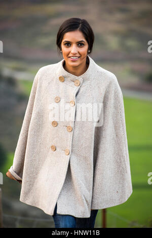 Portrait of smiling woman wearing poncho Banque D'Images