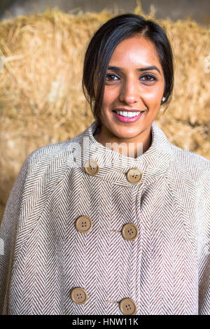 Portrait of smiling woman wearing poncho Banque D'Images