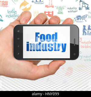 Concept Manufacuring : Hand Holding Smartphone avec l'industrie alimentaire sur l'affichage Banque D'Images