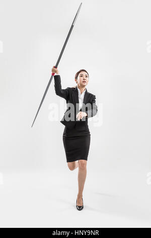 Businesswoman with javelin Banque D'Images