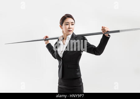 Businesswoman with javelin Banque D'Images