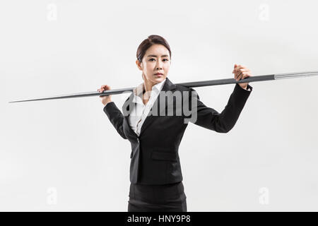 Businesswoman with javelin Banque D'Images