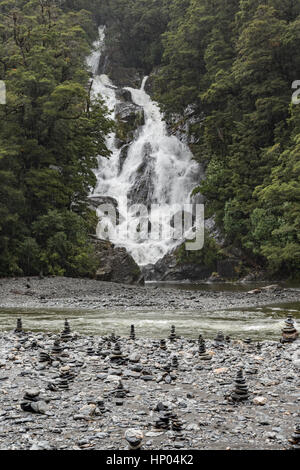 Le Falls et piles de cailloux au large de la route Haast, Mount Aspiring National Park, South Island, New Zealand Banque D'Images