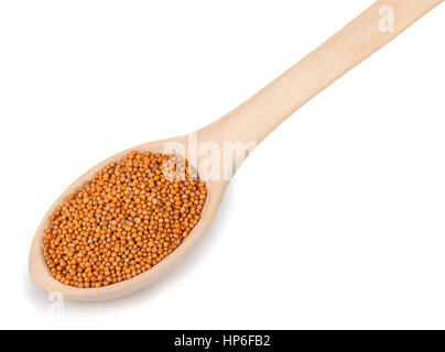 Mustard isolated on white. Les graines de moutarde dans la cuillère en bois isolé sur fond blanc. Les graines de moutarde dans la cuillère en bois Banque D'Images