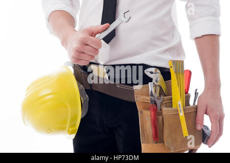 Parution du modèle, Mann im Businessoutfit Bauarbeiterhelm und mit Handwerkszeug - homme dans businessloutfit avec des outils Banque D'Images