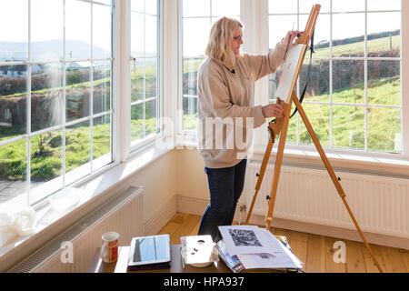 Peinture femme en studio lumineux, la lumière du jour. Banque D'Images