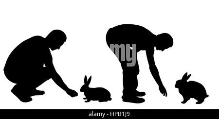 Silhouettes d'hommes nourrir les lapins isolated on white Banque D'Images