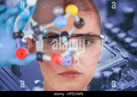 Portrait of female scientist holding molecular model contre détail coup de puce informatique Banque D'Images