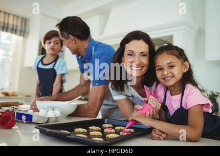 Famille heureuse de préparer des cookies dans la cuisine à la maison Banque D'Images