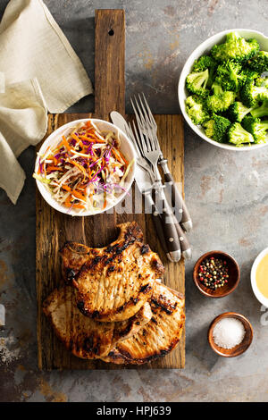 Côtelettes de porc avec salade de chou brocoli à la vapeur et Banque D'Images