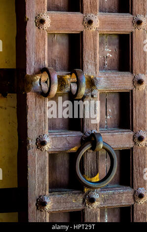 Le Rajasthan, Inde - le 21 novembre 2016 vue : d'une antique porte en bois traditionnel à Kumbhal Garh palace avec un bouton décoratif, knocker et la poignée. Banque D'Images