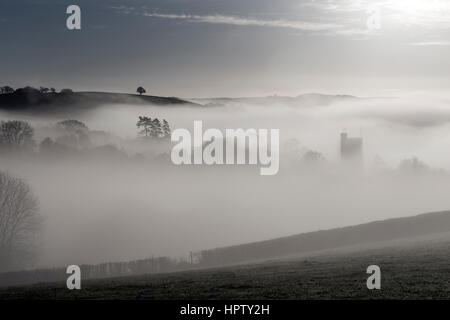 Mist passe au-dessus d'une combe ou coombe une vallée contenant le village de Dunsford dans la Teign Valley,s/n et de chaume,blanchis Dartmoor National Park Banque D'Images