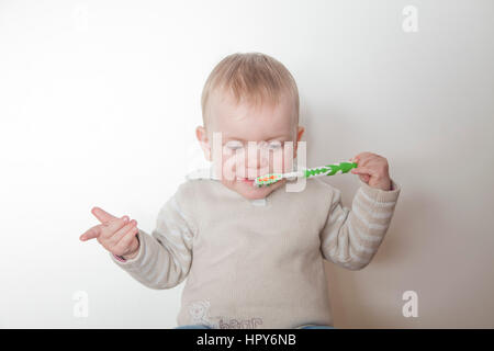 Petite fille se brosser les dents isolé sur fond blanc Banque D'Images