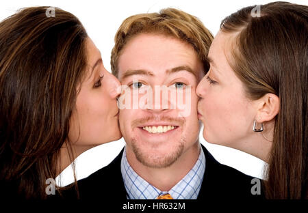 L'homme d'affaires avec deux filles de l'embrasser dans le même temps isolé sur fond blanc Banque D'Images