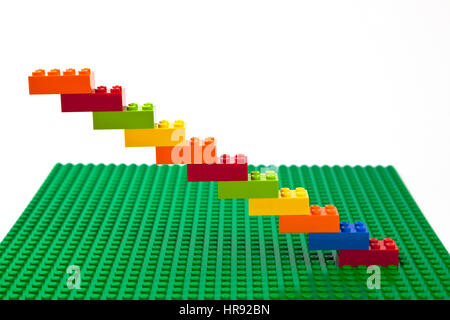 Construction brique Lego colorés d'escalier ou un dessin sur une plaque de base Lego vert. Banque D'Images