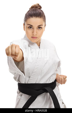 Fille dans un kimono punching isolé sur fond blanc Banque D'Images