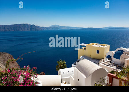 L'architecture traditionnelle méditerranéenne blanc à Santorini, Cyclades, Grèce avec vue sur les toits de la caldera abritée sous le soleil b Banque D'Images