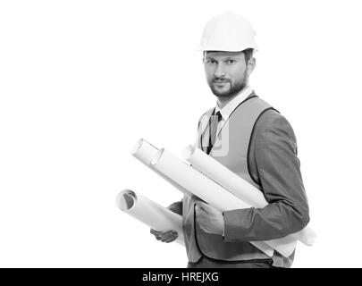 Les plans d'avenir. Portrait noir et blanc d'un certain sérieux mature businessman architect posing on white background holding blueprints constructi Banque D'Images