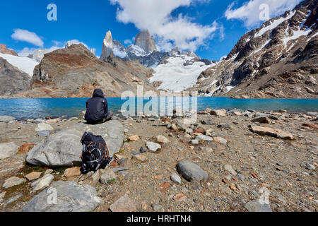 Le dirigeant d'une figure de l'équipement de montagne repose sur des rochers avec vue de Lago de los Tres et le Mont Fitz Roy, Patagonie, Argentine Banque D'Images