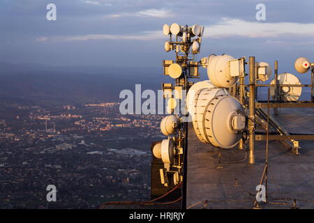 Des émetteurs et antennes sur pylône de télécommunication pendant le coucher du soleil Banque D'Images