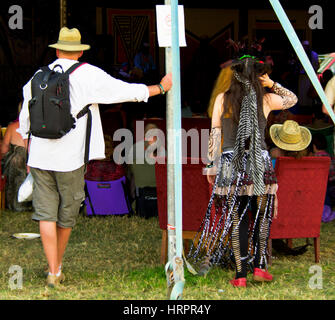 Deux personnes regardant un acte à l'édition 2010 du festival de musique de WOMAD. Banque D'Images