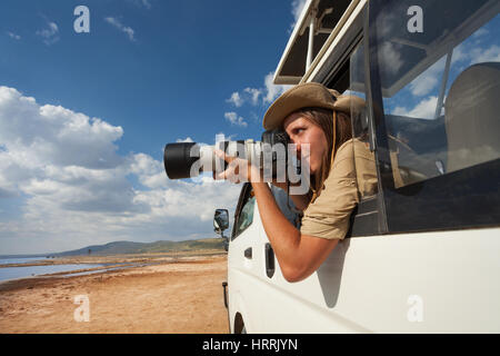 Safari femelle prise de photos touristiques de la fenêtre ouverte de jeep sur safari dans Nakuru Banque D'Images