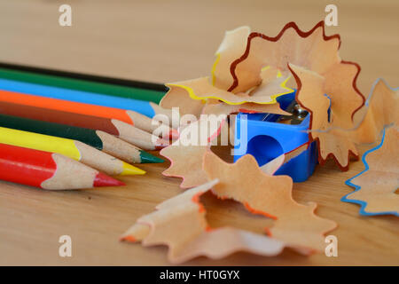 Taille-crayons de couleur, et des copeaux sur table en bois. Profondeur de champ. Banque D'Images