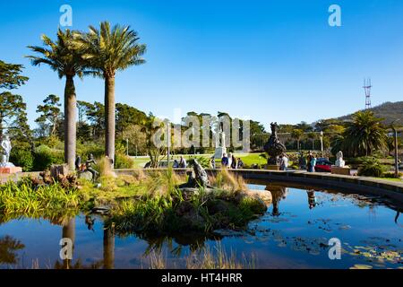 Vue sur le parc du Golden Gate à travers une fontaine, avec des palmiers et de l'Académie des Sciences de Californie visible, San Francisco, Californie, le 14 janvier 2017. Banque D'Images