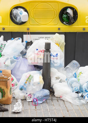Les bouteilles en plastique et sacs entassés contre le recyclage conteneur sur Gran Canaria dans les îles Canaries, Espagne. Banque D'Images