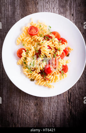 Fussili pâtes avec le cresson et tomates cerises. Banque D'Images