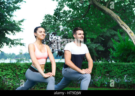 Jeune couple exercising happpy et étirer les muscles avant l'activité sportive Banque D'Images