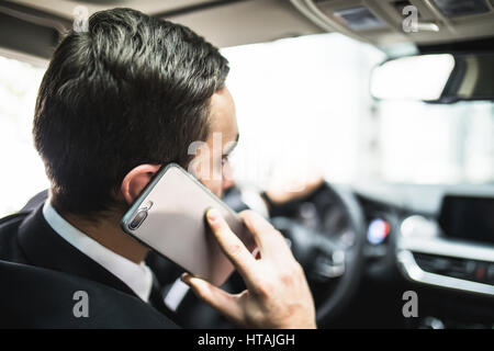 Les transports, les personnes, la technologie et le véhicule concept - close up of man using smartphone au volant d'un véhicule Banque D'Images