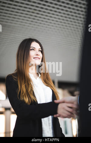 Cheerful young businesswoman, ou client et l'établissement de liaison in office Banque D'Images