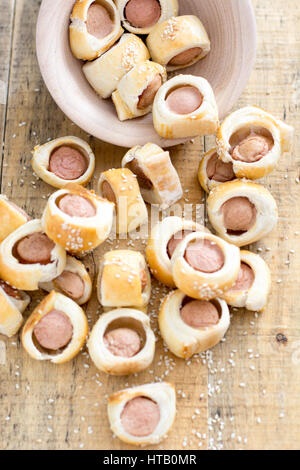 Les porcs fait maison dans une couverture roulée dans les saucisses. pâte de croissant de refroidissement au four sur metal rack avec sésame. selective focus Banque D'Images