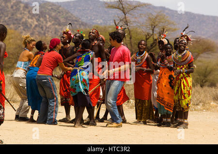 Les guerriers Samburu danse avec les touristes dans un près de manyatta Archers Post, Samburu National Park, Kenya Banque D'Images