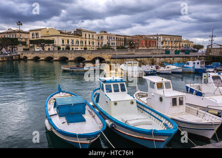Bateaux de pêcheurs locaux à la marina de Syracuse ville, coin sud-est de l'île de la Sicile, en Italie. Pont Umbertino on background Banque D'Images