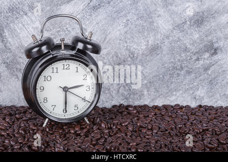 Réveil vintage et les grains de café (Coffee time concept) avec mur en béton Banque D'Images