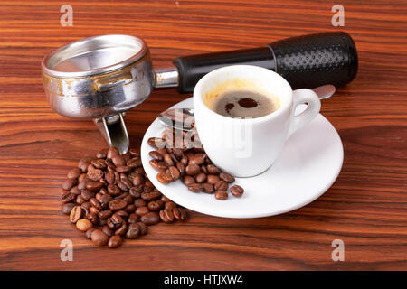 Tasse de café avec les grains de café sur fond de bois Banque D'Images