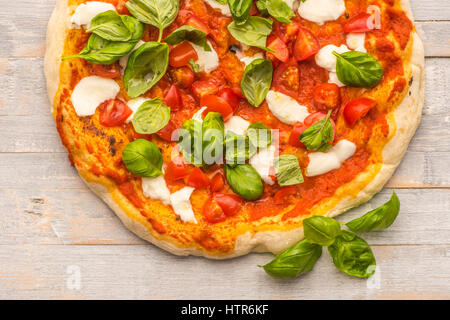 Pizzas au feu de bois fait Feshly vus du dessus sur cartes gris rustique Banque D'Images