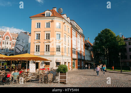 Riga, Lettonie - 1 juillet 2016 : Les gens se reposant dans Street Cafe Restaurant dans la vieille ville de façades de vieille architecture et bâtiments près de la Place du Dôme à Sun Banque D'Images