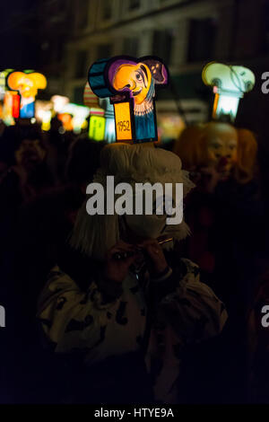 Carnaval de Bâle 2017. Un participant de carnaval avec lanterne tête lumineuse jouant piccolo lundi matin dans les rues. Banque D'Images