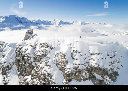 Homme debout sur la montagne couverte de neige en tenant une dronie, Salzbourg, Autriche Banque D'Images